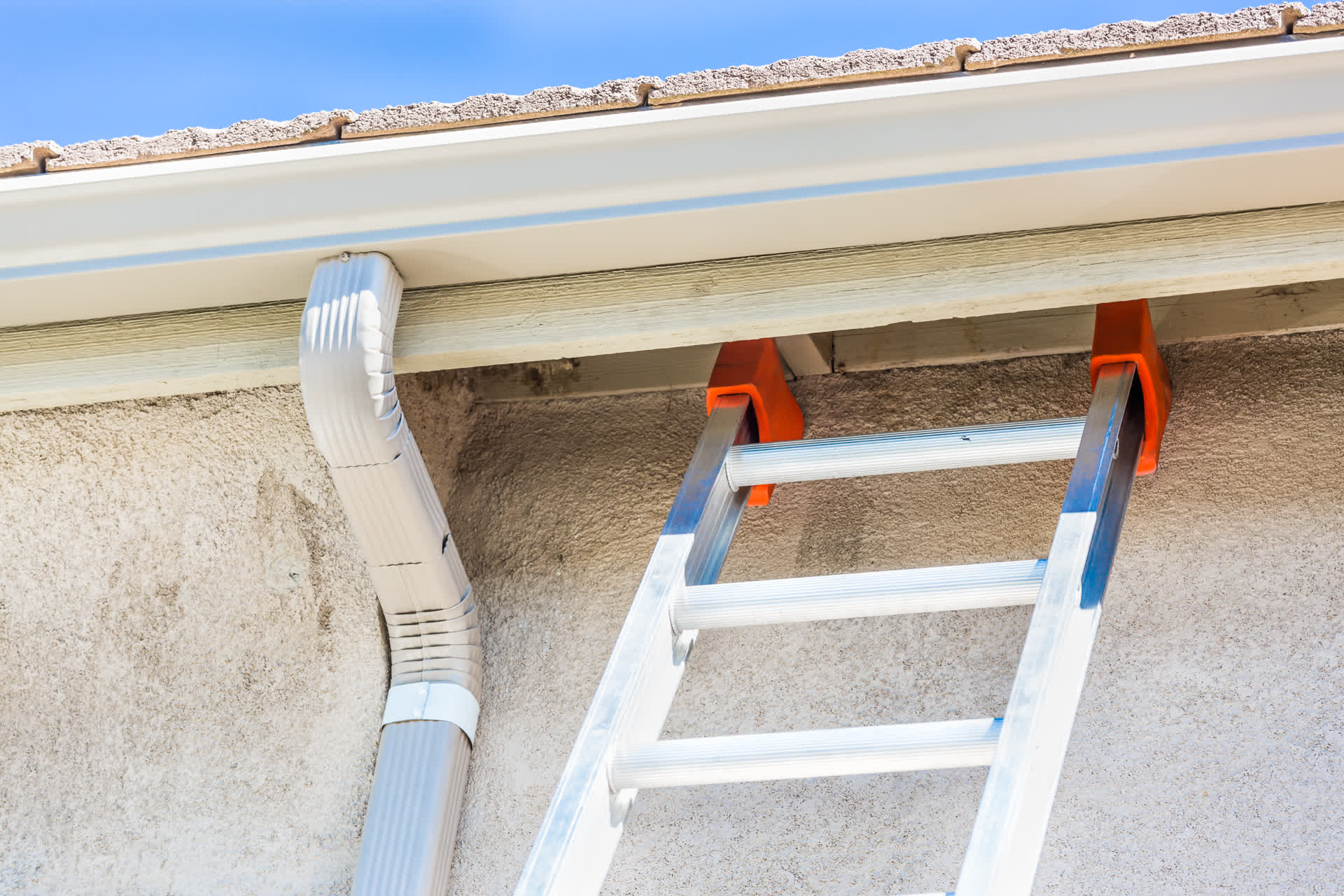 Gutter system installed along residential roofline