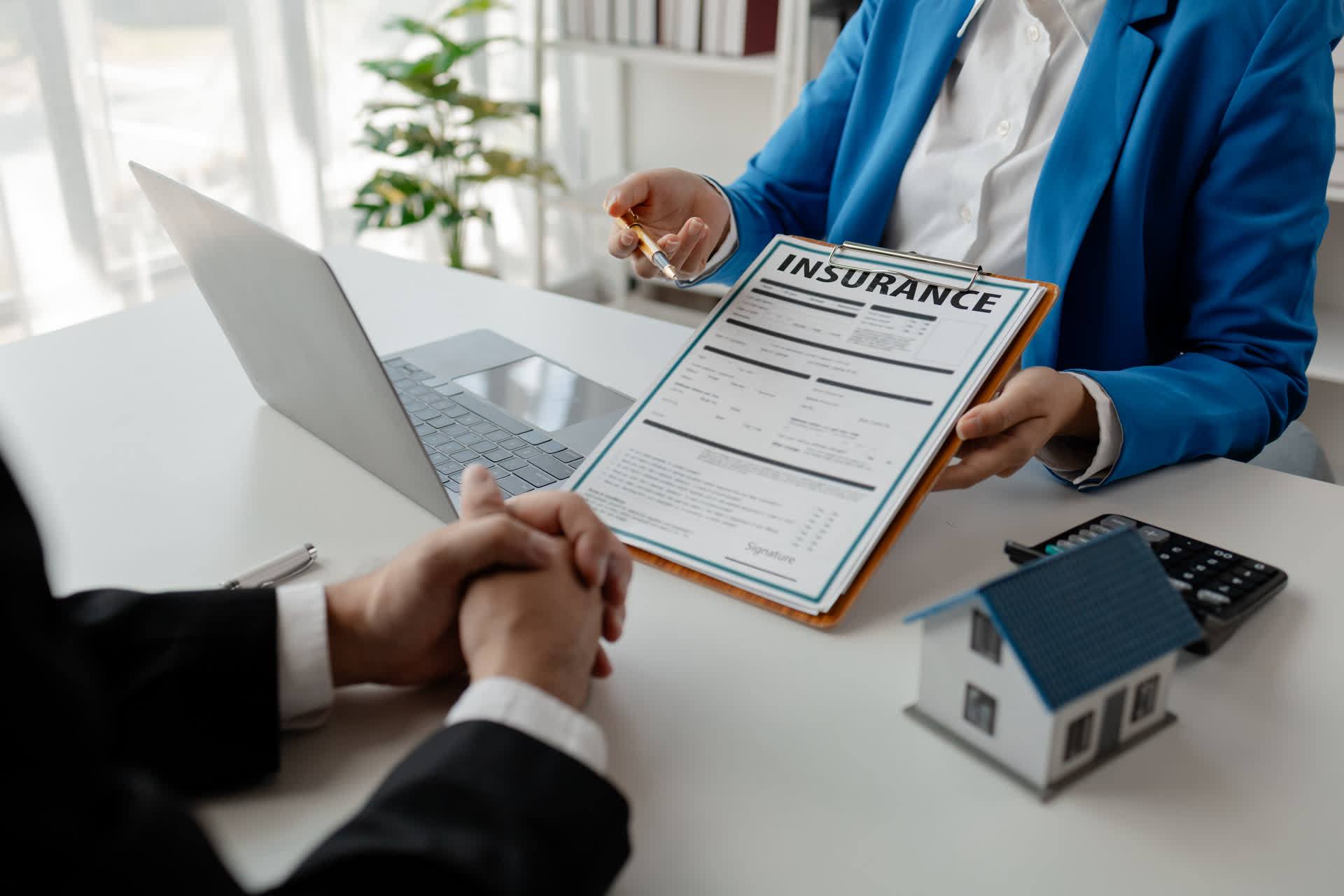 Homeowner reviewing roofing insurance claim paperwork
