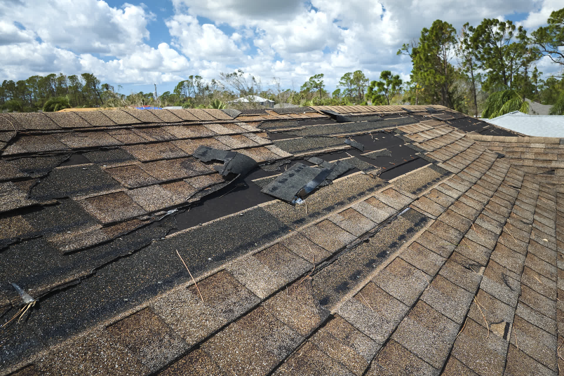 Worn shingles on commercial roof needing maintenance