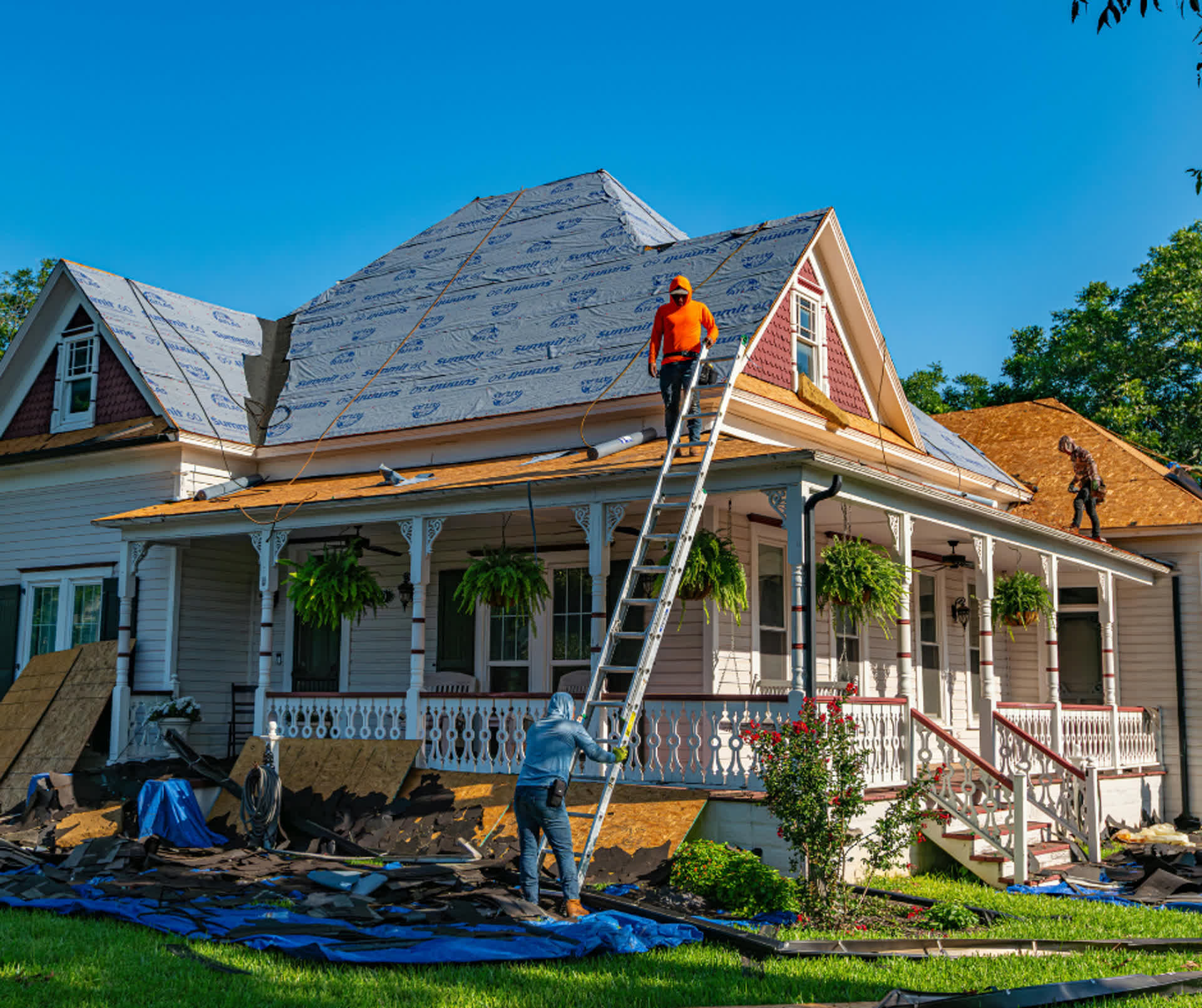 Roofing crew working on residential home exterior