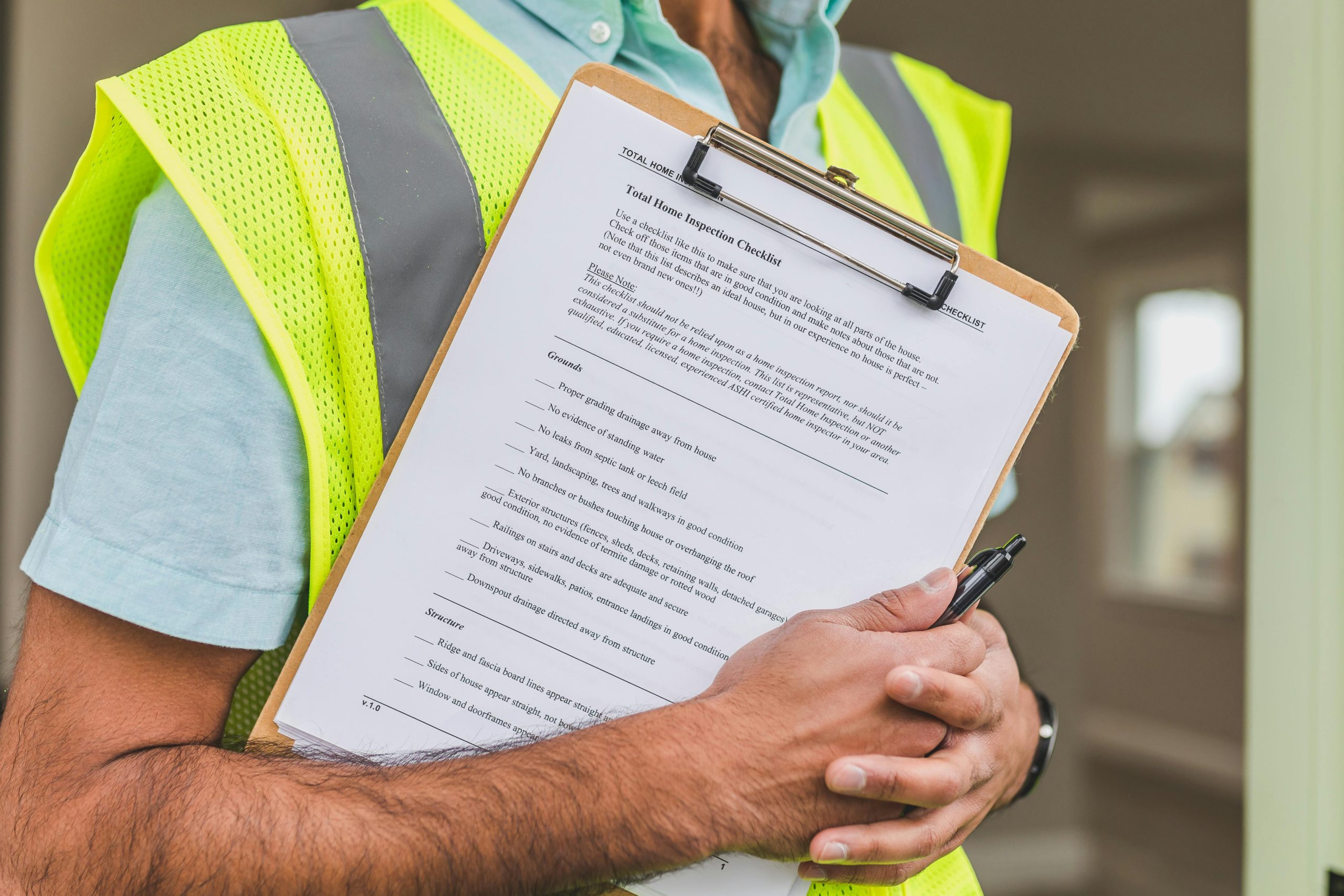 Contractor reviewing roof inspection checklist on clipboard